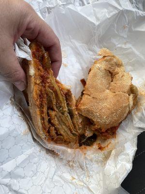 Eggplant Parmesan on a hard roll with fried peppers added