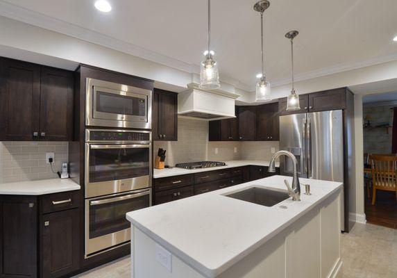 New Cabinets with updated lighting, big island with beautiful sink and a wall of appliances!