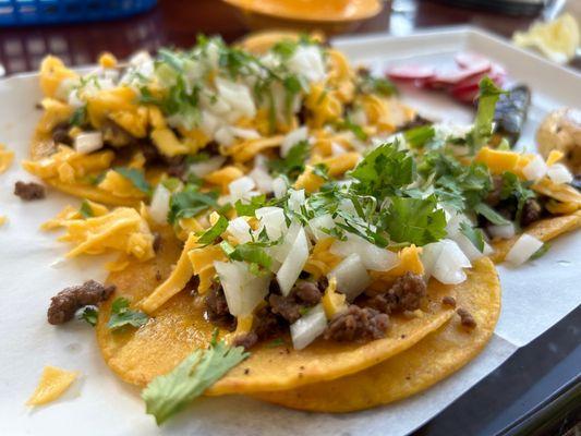 Street tacos with yellow cheese