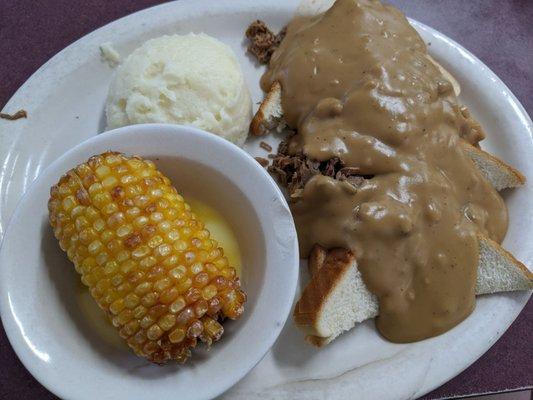 Open-faced roast beef with creamed potatoes and deep-fried corn on the cob