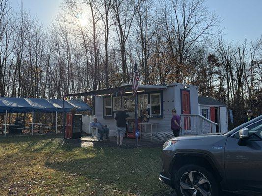 The food stand & tent on the side with picnic tables.