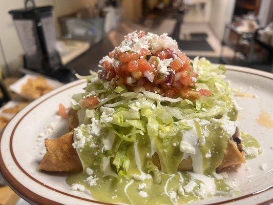 Smoked pork butt taquitos with sour cream, pico de Gallo, avocado sauce and cotija cheese.