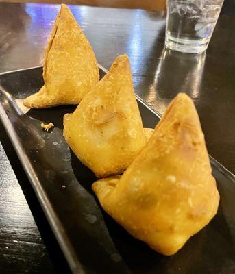 Vegetable Samosa - 3 Pieces, crisp patties stuffed with potatoes, green peas and spices served with a Mint and Sweet Sauce.