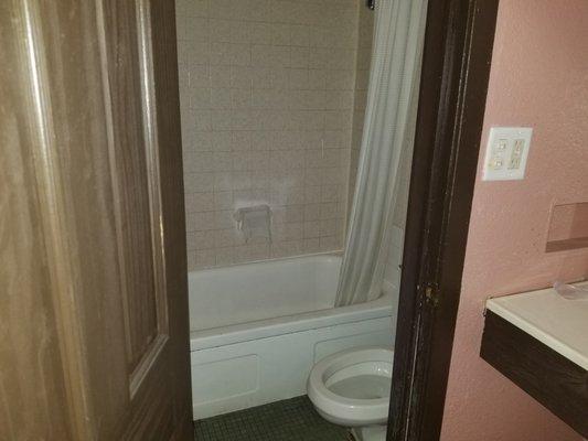 Extremely small bathroom with a toilet which barely flushes.