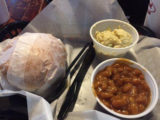 smoked chicken sandwich and 2 sides of baked beans and potato salad