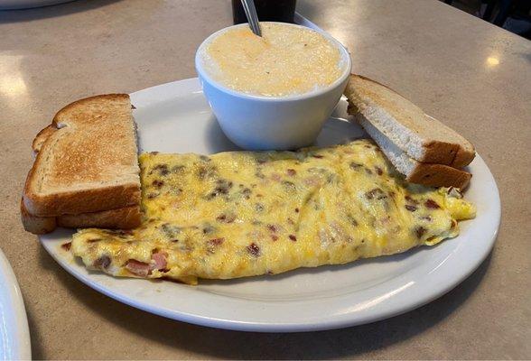 Meat lovers omelette with grits and toast