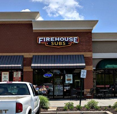 Front of Firehouse Subs in the strip mall with entrance in front and back of business.