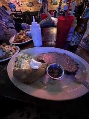 Prime rib with potatoes, grilled sauerkraut, and salad.