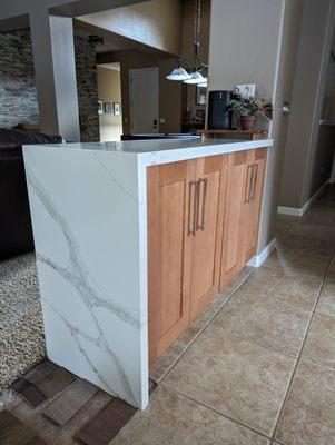 Replaced our old cabinet with this one and included the waterfall edge. We are still finishing our carpet after removing a previous post.