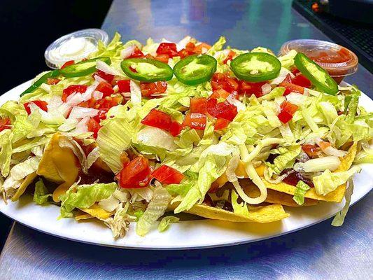 The "Loaded Nacho's", with sides of Sour Cream and Salsa.