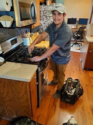 Technician Kenneth repairing a stove!