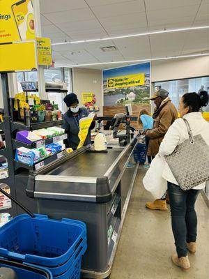 Cashier helping a customer at the checkout counter @ Lidl