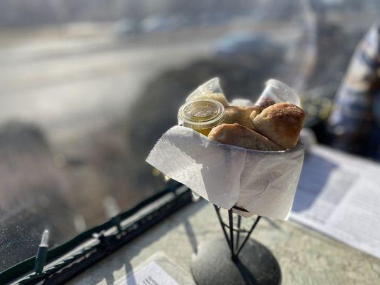 Complimentary bread with individual oil, Parmesan cheese and red pepper flakes. March 2021.