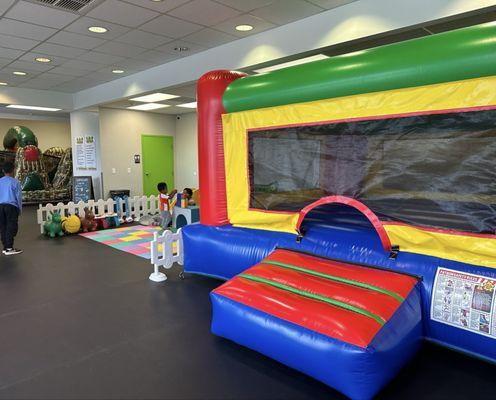 One of the bouncy houses next to an interactive toddler play area