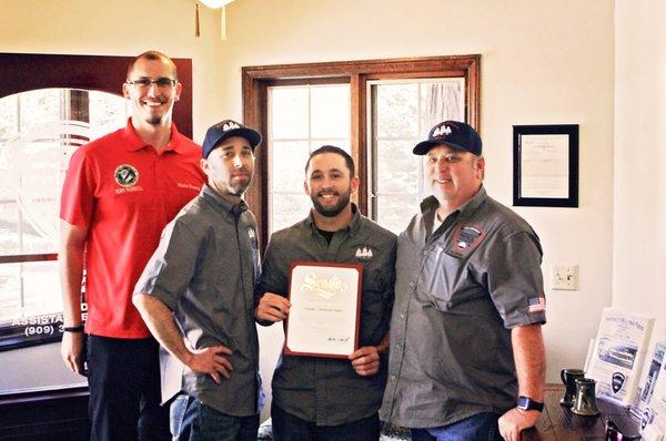 Ron, Ronnie & Nick accepting certificate from Senator's office