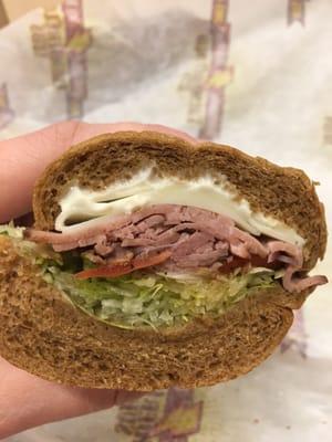 Roast beef on wheat with everything. Can't see all the thinly sliced red onion yet, but they're in there!