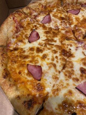 Pic of the tiny quarters of canadian bacon on our large pizza. Ridiculously sad and not like any pizza I've ever ordered anywhere!