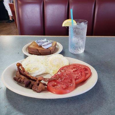 Breakfast.  2 eggs, bacon,  tomatoes, and toast.   Total including tax 8.98.   Cheaper options at other mom and pop places.