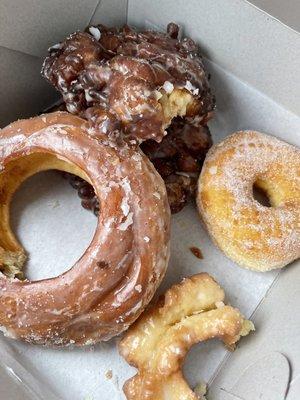 Half dozen custom: glazed honey bun, 2 fritters, sugar coated,  French Cruller (devoured),  Cake Donut (half eaten)