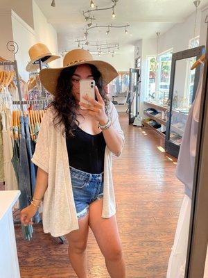 Basic bombshell fit including: bombshell sun hat, off white cardigan, black bodysuit, cuffed denim shorts