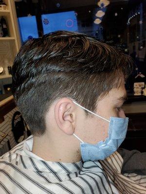 Side view of a young man's classic  haircut  by Jessica Owner Master  stylest Barber