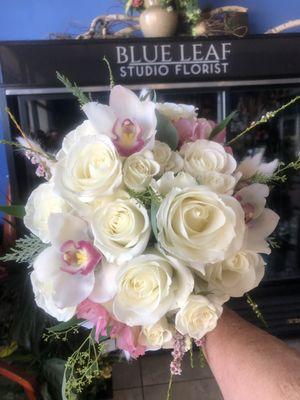 Medium sized Bridal bouquet. White roses, and cymbidium ordhids.