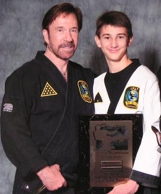 Master Austin Jamieson receiving 1st place from Chuck Norris in forms against over1500 competitors.