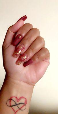 Medium length coffin nails, gold foil, matte mauve and gold stones.