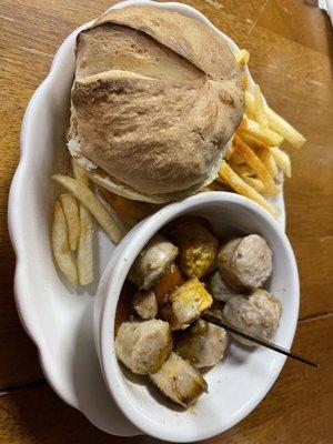 White bratwurst with curry, britches and seasoned fries.