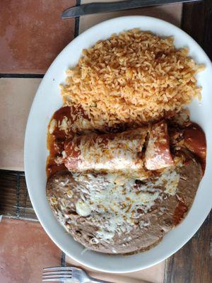 Ground beef enchilada with rice and refried beans; Lunch special #3.