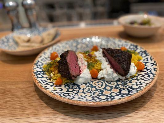 Hawaij-Spiced Shortrib served with labneh, saffron rice, pistachios, and kumquats