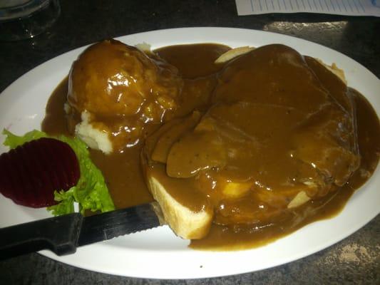 Hot roast beef sandwich with potatoes and gravy.