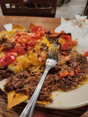 Mushy plate of nachos . Big pile of mush...