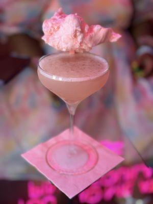 Pink lemonade cosmopolitan with cotton candy as garnish