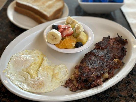 Delicious homemade classic corned beef & eggs with fruit salad side and GF toast.