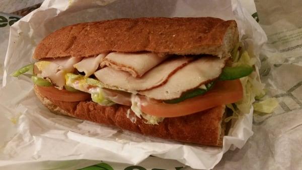 Turkey swiss lettuce tomatoes onions black olives green bell peppers mayo and mustard -- closed