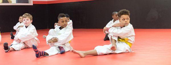 Kids class stretching before class.