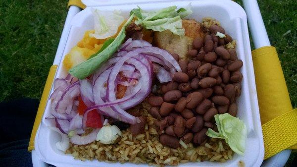 Brown rice with beans, roasted chicken leg, potato's on top left with a bit of salad on top