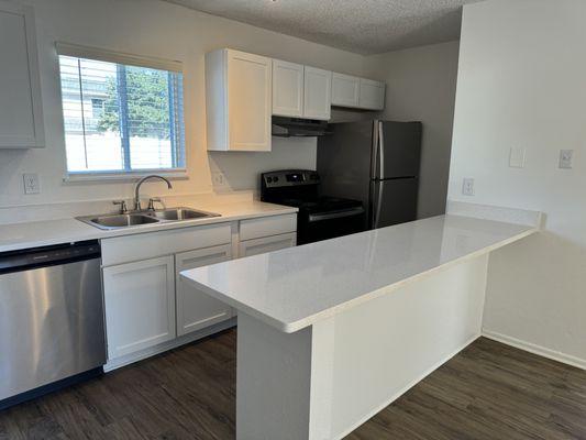 Kitchen with stainless steel appliances and quartz countertops