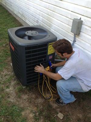 Technician performing AC Check Up by Absolute Clean HVAC