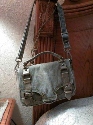 Her purses are to die for cute! I love this one I bought. The purse is made from recycled military material! Gives it so much character.