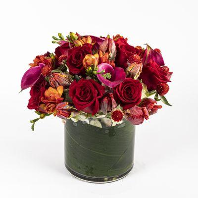 red arrangement with roses, tulips and freesia