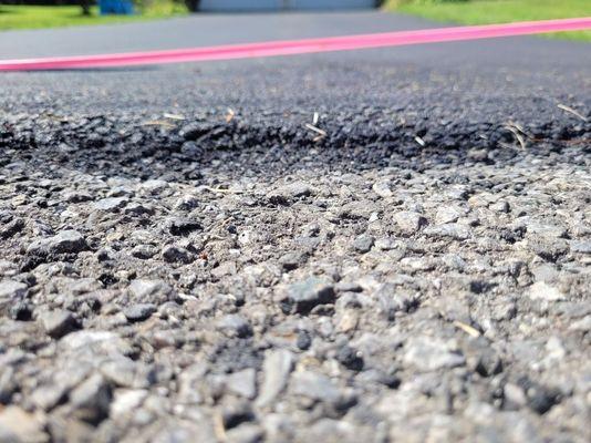 Here's  the drop off from the driveway to the street. As you can see by the tape across the driveway, this was "finished work".