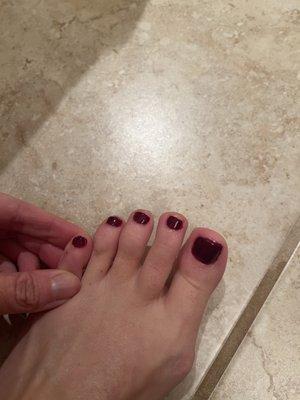 Every single toe has polish on the skin. Why is the pinky toenail length longer than the other 3 next to it??