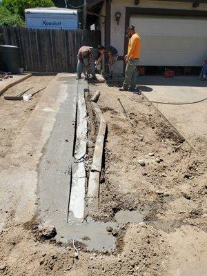 Edgar made a dirt "dam" so the water from the concrete cutter wouldn't go down the storm drain to the creek.