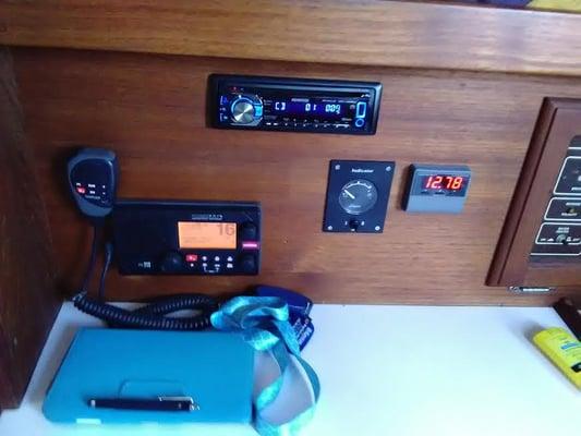 VHS radio, stereo, solar panel and battery amps display, electrical panel, fresh and waste tank levels gauge