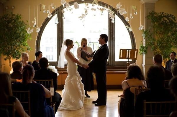 Wedding ceremony with strung origami decorations.