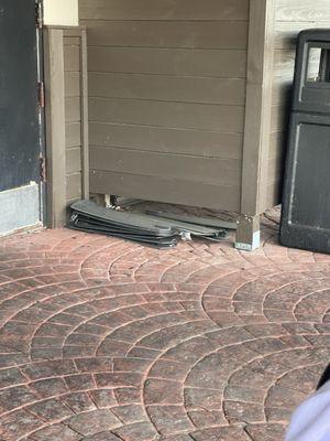 The broken fan blades are stacked on the patio