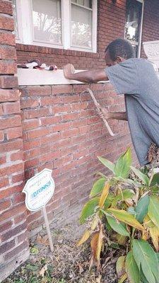 men in action, Raking out damaged mortar