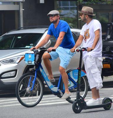 Leonardo DiCaprio enjoys the day with his friend Danny riding a scooter